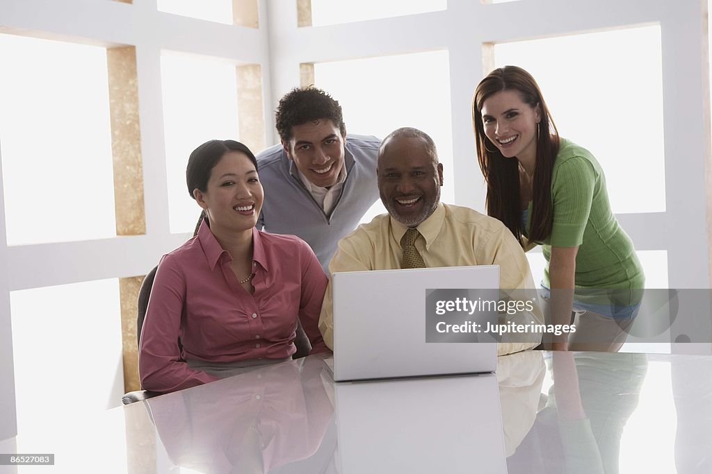 Businesspeople working on laptop