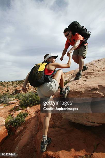 couple climbing rocks - couple grand canyon stock pictures, royalty-free photos & images