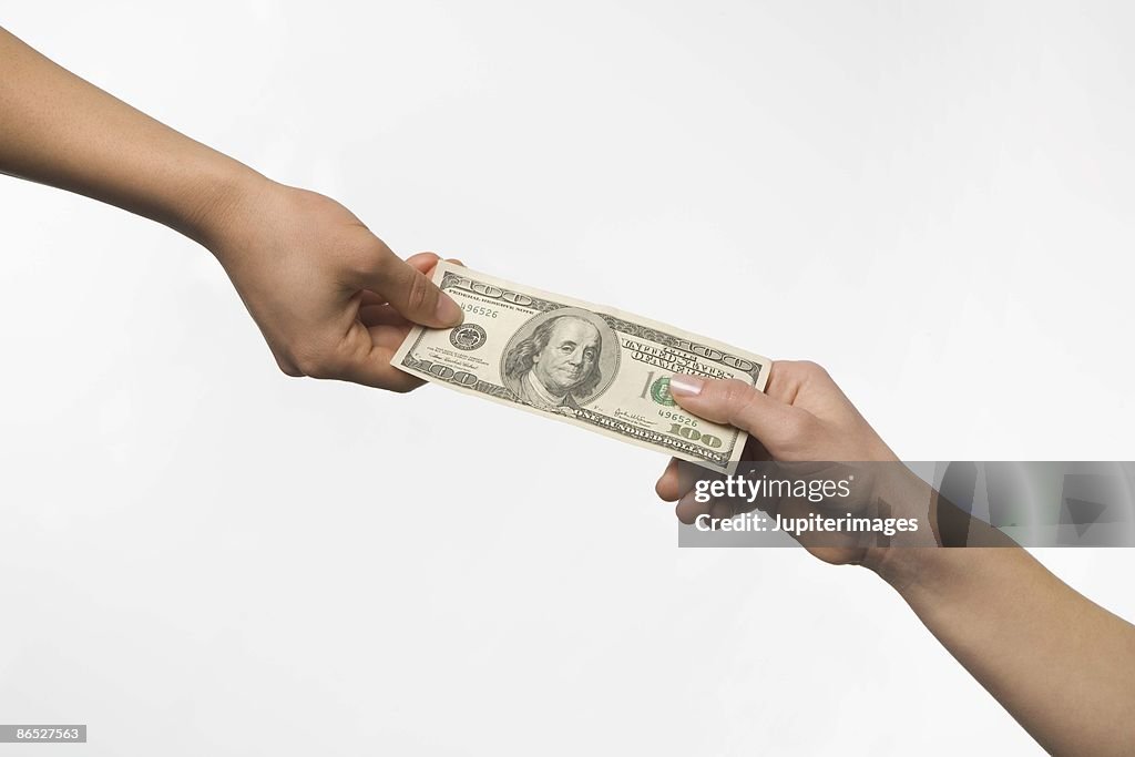 Hands exchanging money