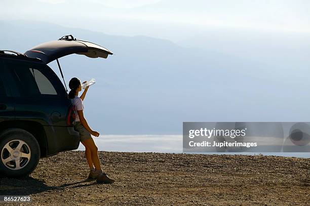 woman taking a break on desert overlook - heat haze car stock pictures, royalty-free photos & images