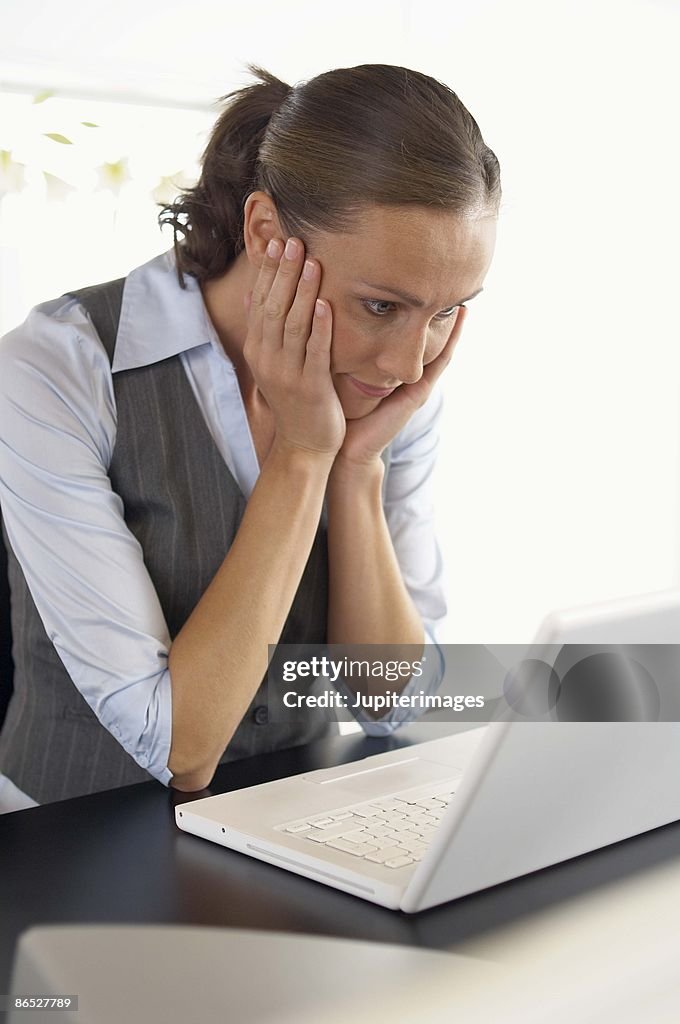 Woman working on laptop in office