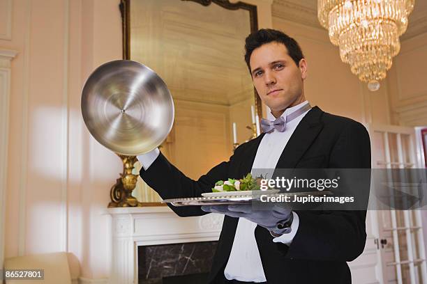 butler removing dome from tray - domed tray photos et images de collection