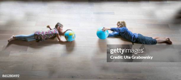 Sankt Augustin, Germany Two children hold a globe in their hands and fly towards each other on August 08, 2017 in Sankt Augustin, Germany.