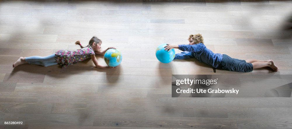 Flying children with globes