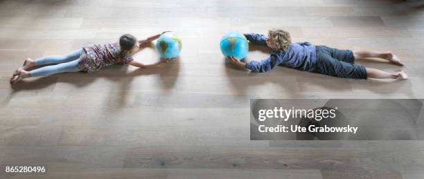 Sankt Augustin, Germany Two children hold a globe in their hands and fly towards each other on August 08, 2017 in Sankt Augustin, Germany.
