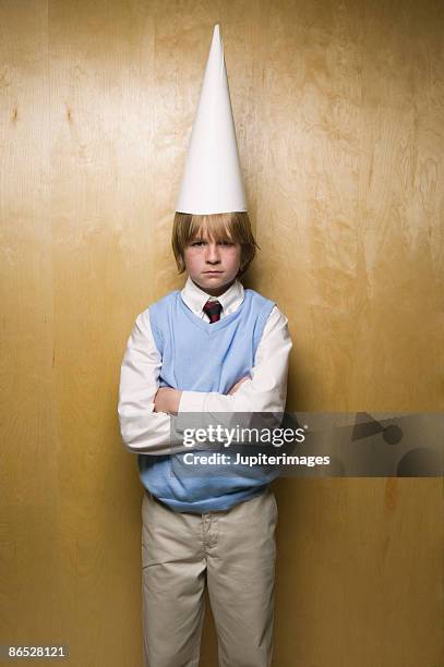 boy wearing dunce cap - dumstrut bildbanksfoton och bilder