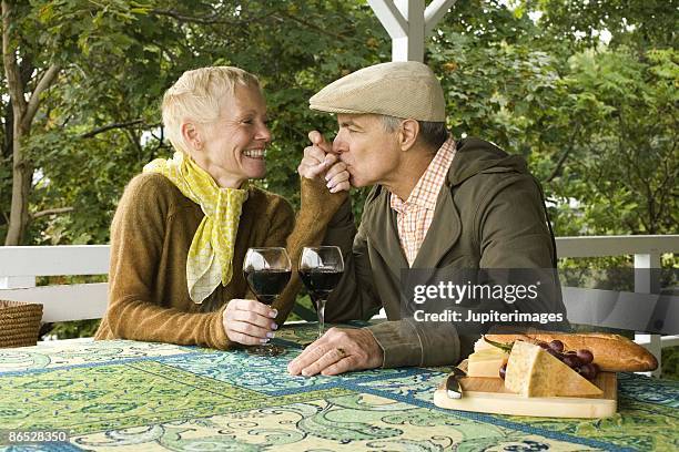 couple drinking wine - kyssa på handen bildbanksfoton och bilder