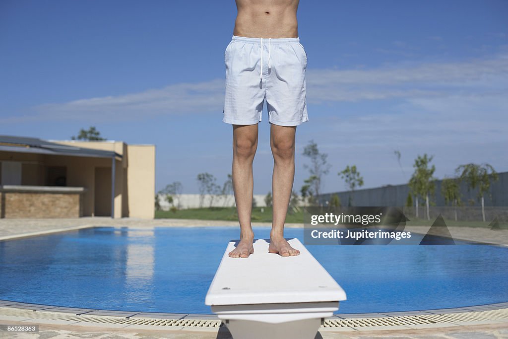 Man standing on diving board