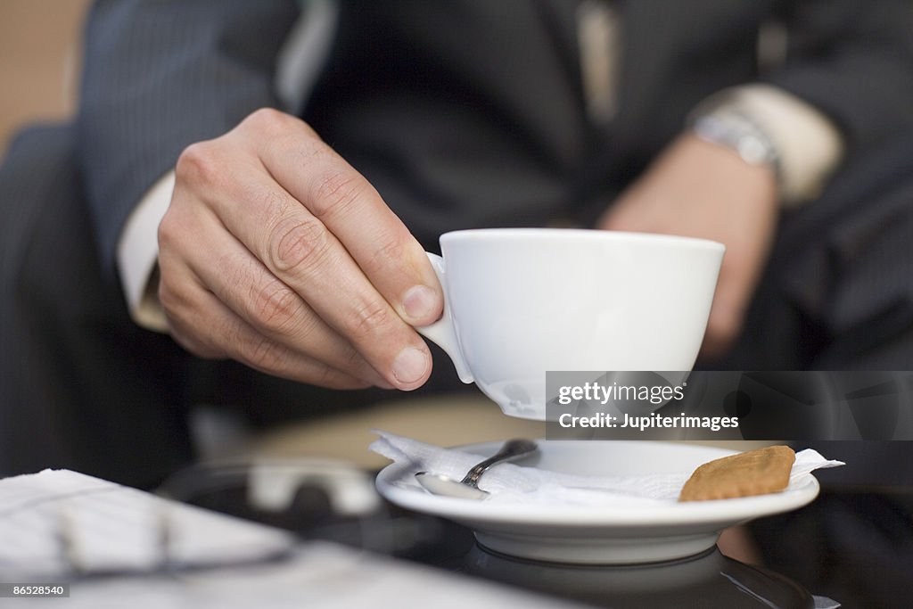 Hand holding coffee cup