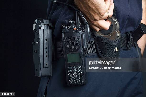 police officer with handcuffs - holster stock pictures, royalty-free photos & images