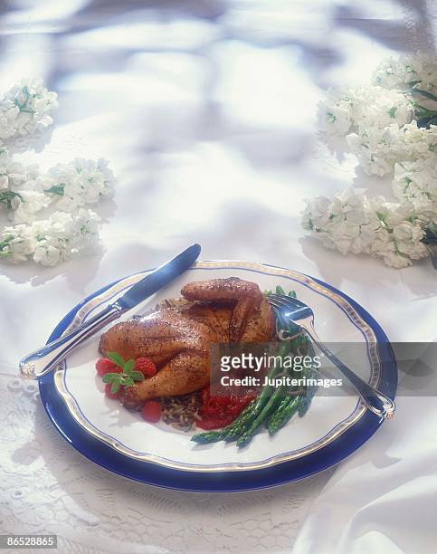 chicken dish with raspberry sauce and asparagus - raspberry coulis stock pictures, royalty-free photos & images