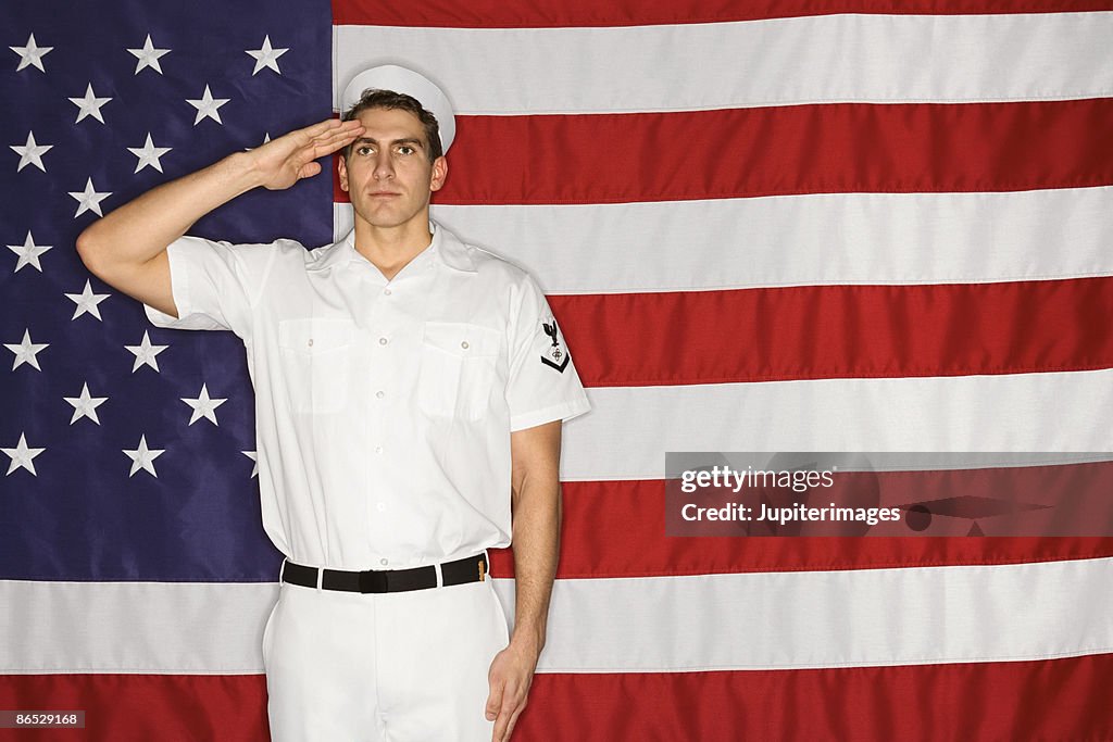 Sailor saluting and American flag