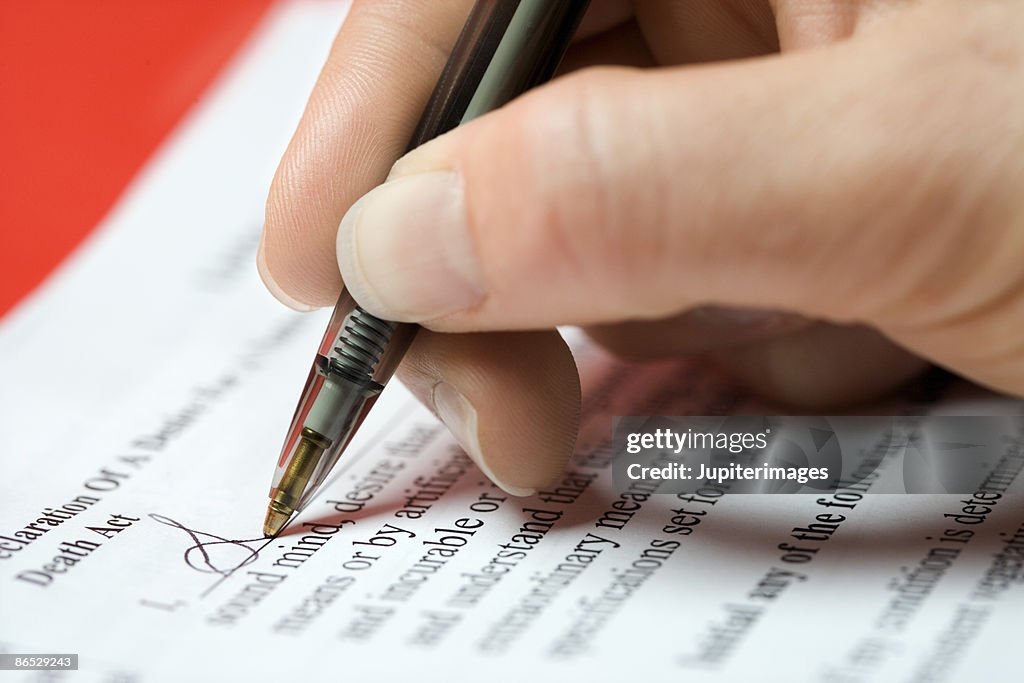 Woman signing legal document