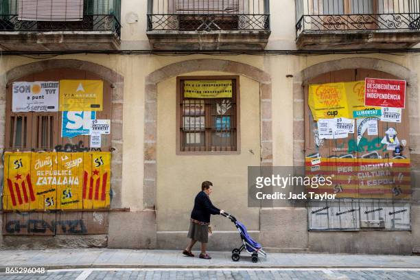 Woman walks past Catalan pro-independence graffiti on October 23, 2017 in Barcelona, Spain. The Spanish government is to take steps to suspend...