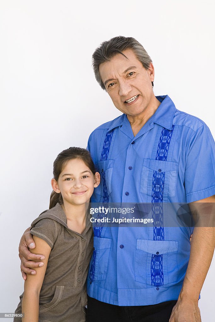 Grandfather and granddaughter smiling