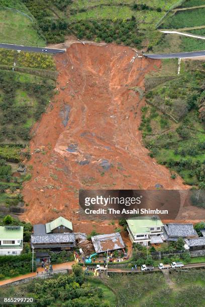 In this aerial image, houses engulfed by a landslide is seen after powerful Typhoon Lan hit past on October 23, 2017 in Kinowaka, Wakayama, Japan. A...