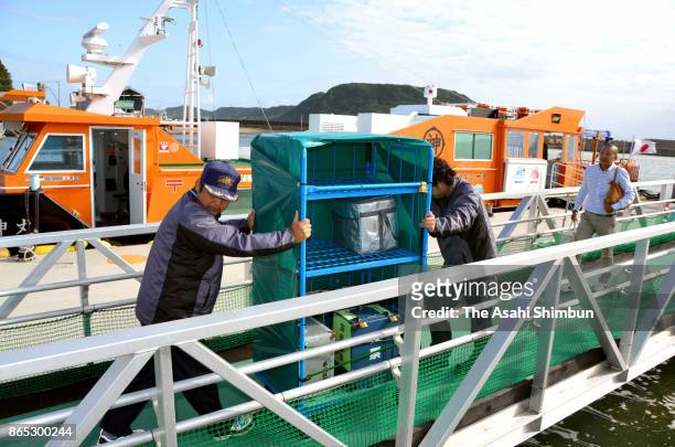 Boxes containing ballot papers arrive at a port a day after the general election as it is delayed by bad weather due to Typhoon Lan hit past Japan on...