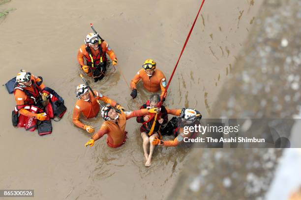 Man, one of eight people stranded in a holm by the Tamagawa river is winched to safety after Typhoon Lan hit past Japan on October 23, 2017 in Tokyo,...