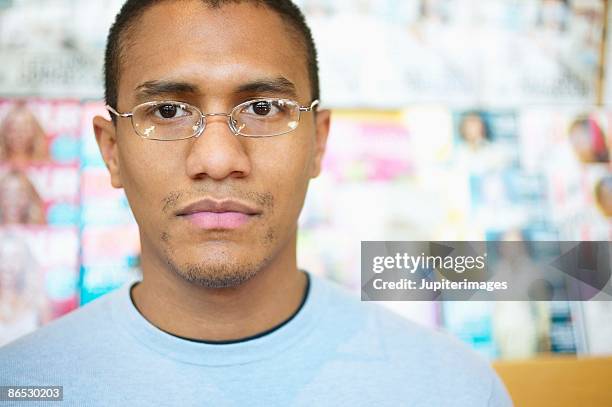 portrait of man by magazine rack - magazine rack stock pictures, royalty-free photos & images