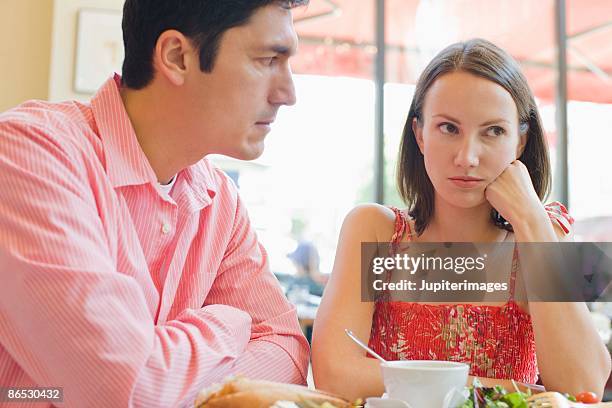 couple arguing in cafe - mid adult couple stockfoto's en -beelden