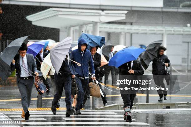 Commuters walk in the strong wind and rain as Typhoon Lan hit past Japan on October 23, 2017 in Fukui, Japan. Powerful Typhoon Lan left at least two...