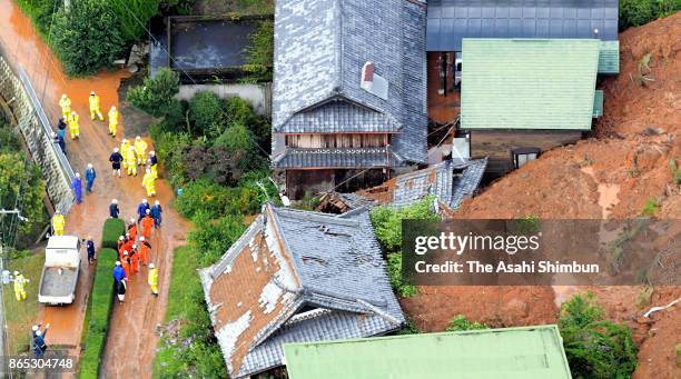 In this aerial image, houses engulfed by a landslide is seen after powerful Typhoon Lan hit past on October 23, 2017 in Kinowaka, Wakayama, Japan. A...