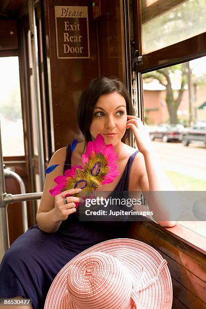 woman on trolley with masquerade mask - new orleans streetcar stock pictures, royalty-free photos & images