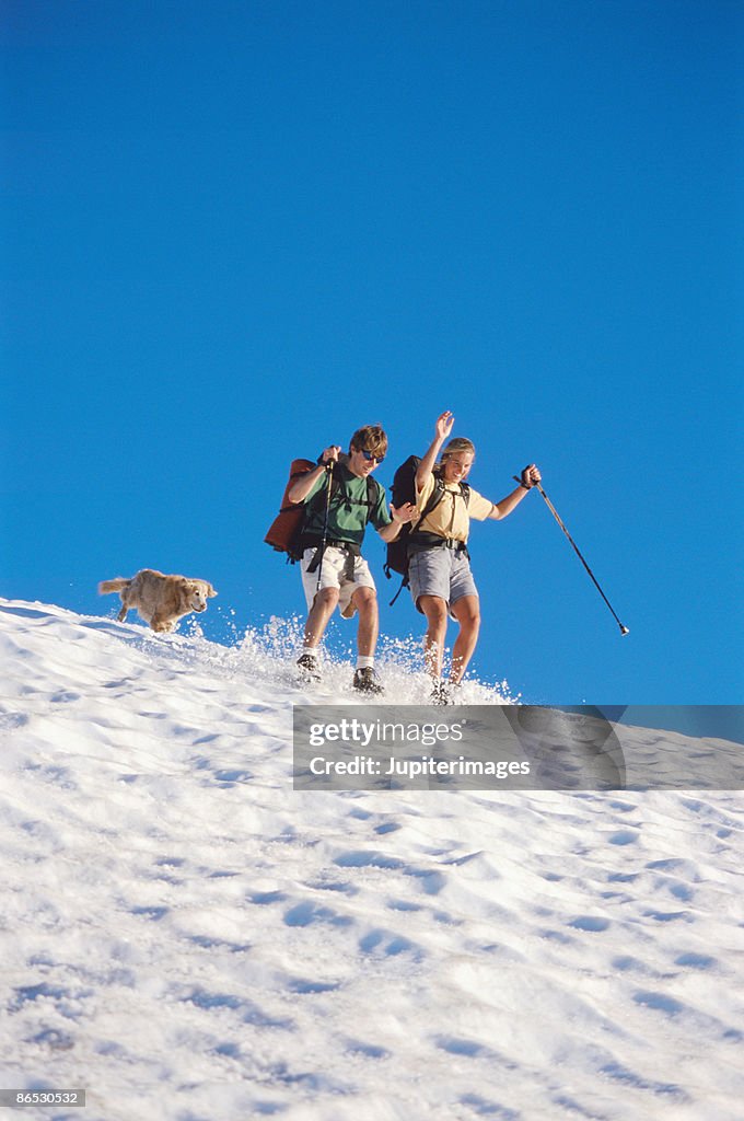 Couple sliding in snow