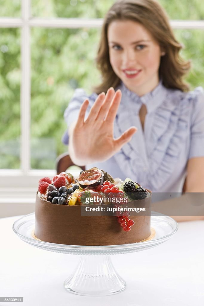 Woman declining chocolate cake