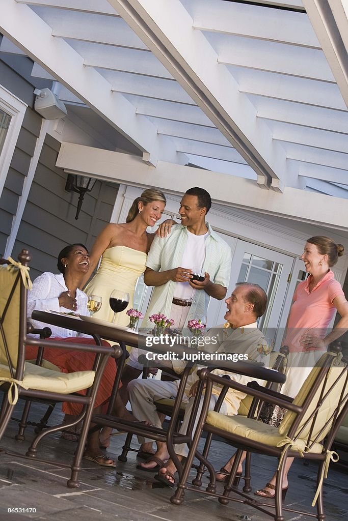 Friends relaxing on patio together