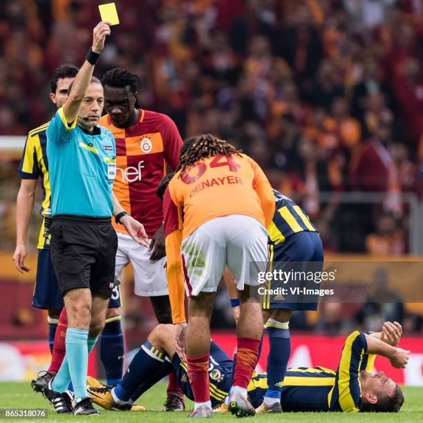 Referee Cuneyt Cakir give Jason Gregory Denayer of Galatasaray SK a yellow card after a faul at Vincent Janssen of Fenerbahce SK during the Turkish...