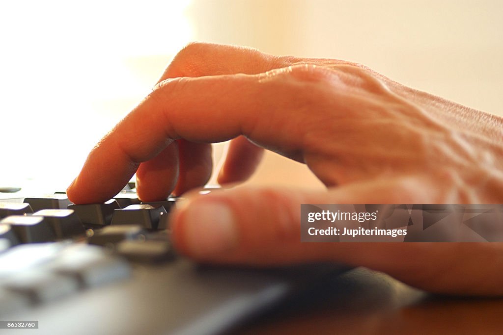 Hand typing on keyboard