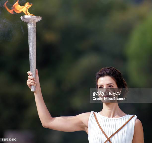 High priestess passes the Olympic flame at the Temple of Hera during a dressed rehearsal of the lighting ceremony of the Olympic flame in ancient...