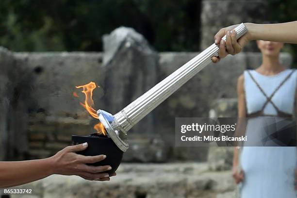 High priestess passes the Olympic flame at the Temple of Hera during a dressed rehearsal of the lighting ceremony of the Olympic flame in ancient...