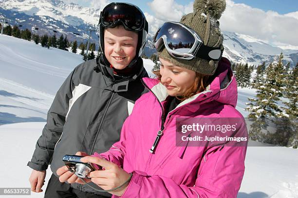 woman and boy looking at digital camera - balaclava boy stock pictures, royalty-free photos & images