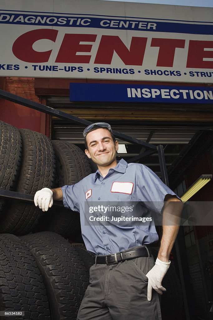 Mechanic with rack of tires