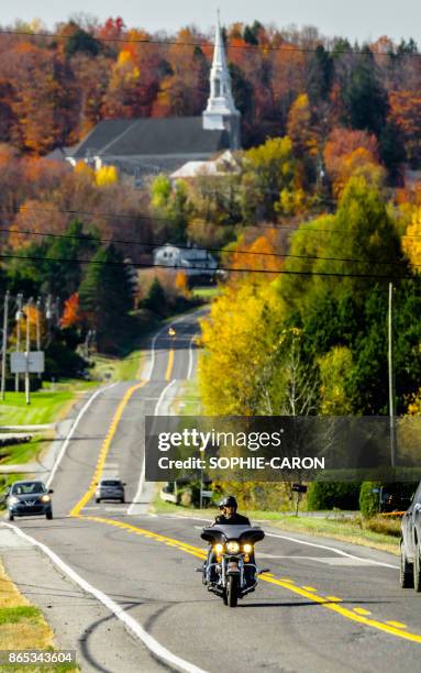 church in the eastern townships, autumn, motorcyclist. - eastern townships quebec stock pictures, royalty-free photos & images