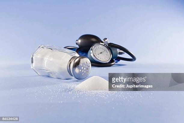 blood pressure cuff and salt - salt shaker stock pictures, royalty-free photos & images