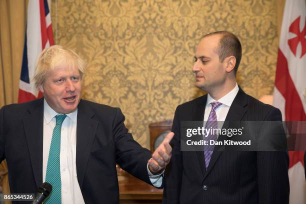 Britain's Foreign Secretary Boris Johnson greets Georgia's Foreign Minister Mikheil Janelidze at the Foreign and Commonwealth Office on October 23,...