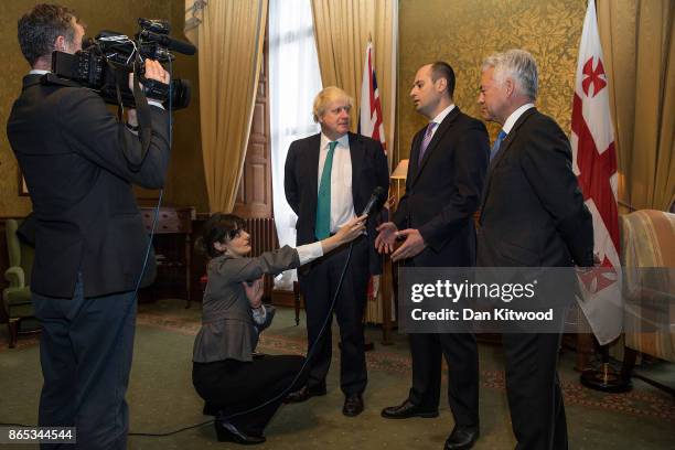 Britain's Foreign Secretary Boris Johnson greets Georgia's Foreign Minister Mikheil Janelidze at the Foreign and Commonwealth Office on October 23,...