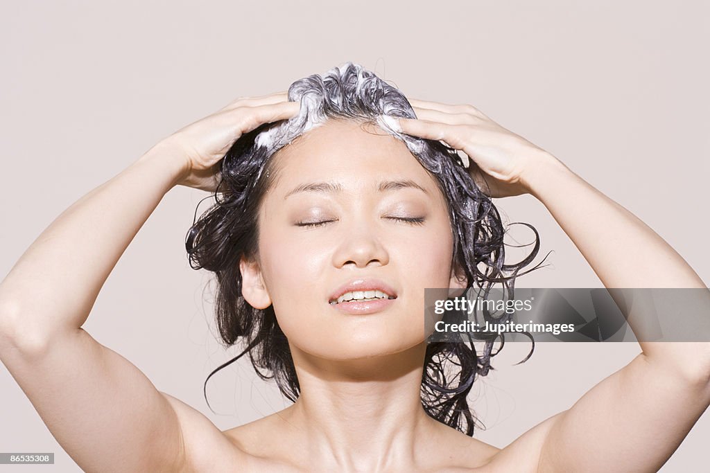 Woman lathering shampoo