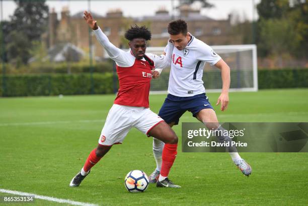 Aaron Eyoma of Arsenal is held back by Anthony Georgiou of Tottenham during the match between Tottehma Hotspur and Arsenal on October 23, 2017 in...