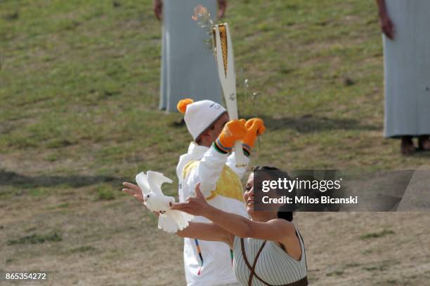 High priestess passes the Olympic flame during a dressed rehearsal of the lighting ceremony of the Olympic flame in ancient Olympia on October 23,...