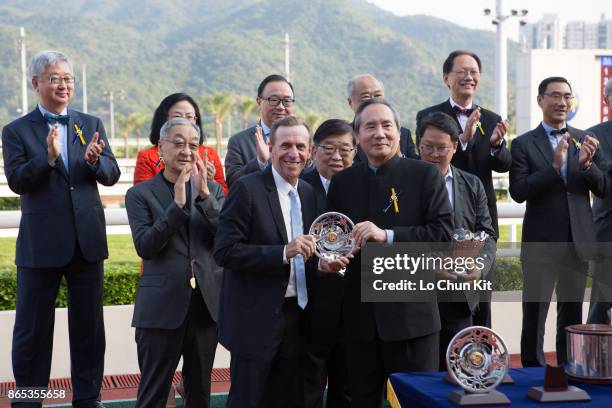 Steward Stephen Ip Shu Kwan presents the Premier Bowl silver dishes to the winning trainer John Size at Sha Tin racecourse on October 22, 2017 in...