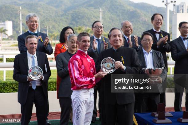 Steward Stephen Ip Shu Kwan presents the Premier Bowl trophy and silver dishes to the winning jockey Nash Rawiller at Sha Tin racecourse on October...