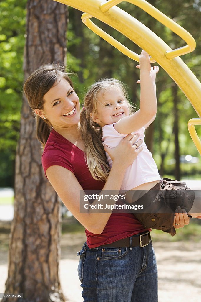 Smiling mother and daughter playing