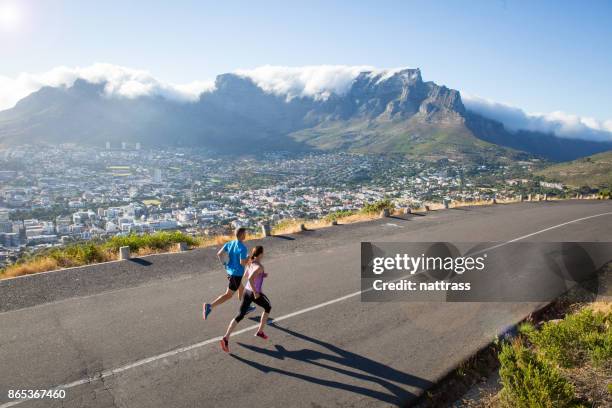 running on a beautiful day above the city - road running stock pictures, royalty-free photos & images