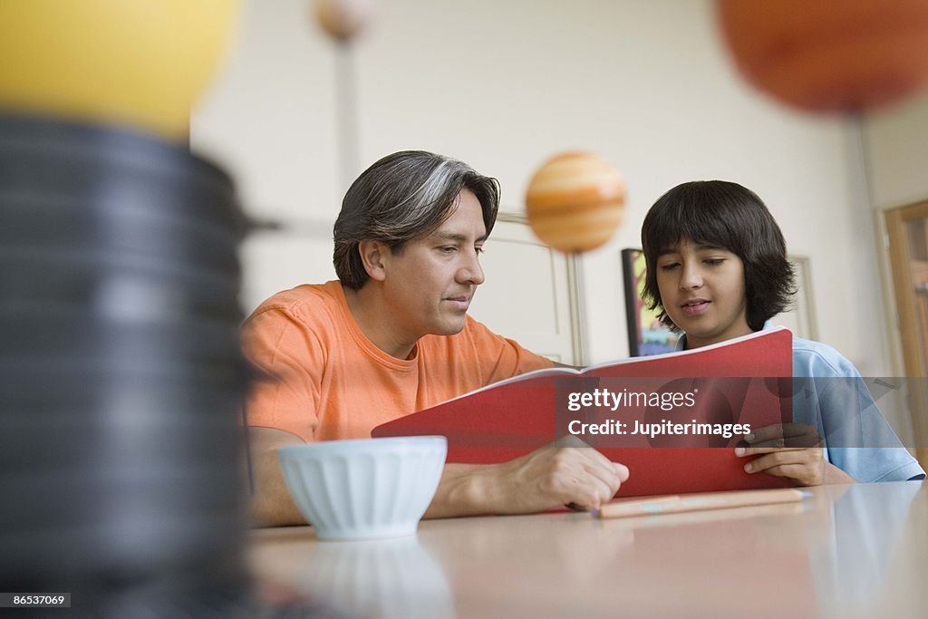 Father helping son with homework