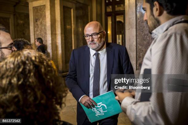 Lluis Corominas, spokesman of Junts Pel Si or "Together for Yes" party, holds a document following a meeting inside the Generalitat regional...