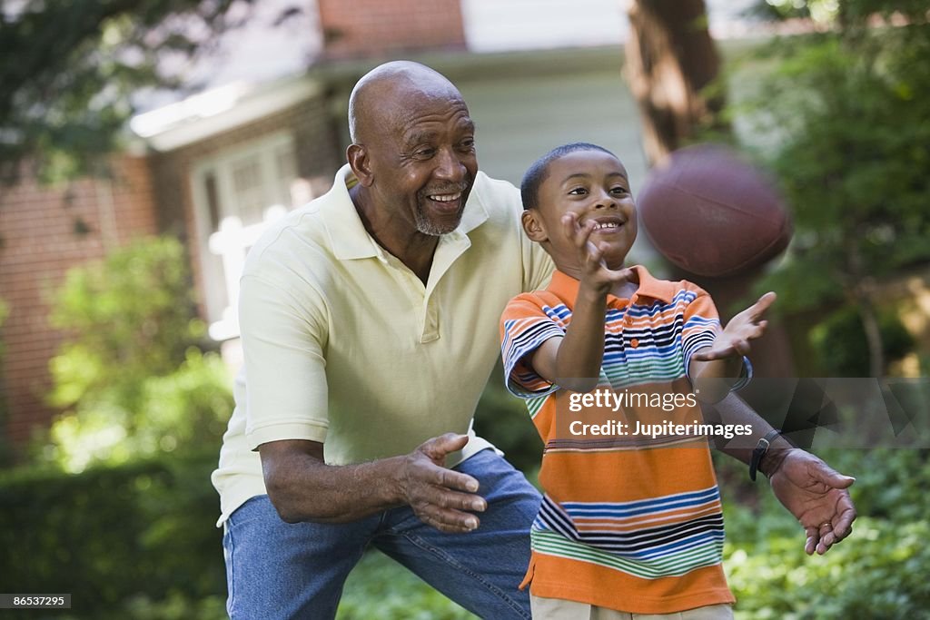 Grandfather and grandson playing football